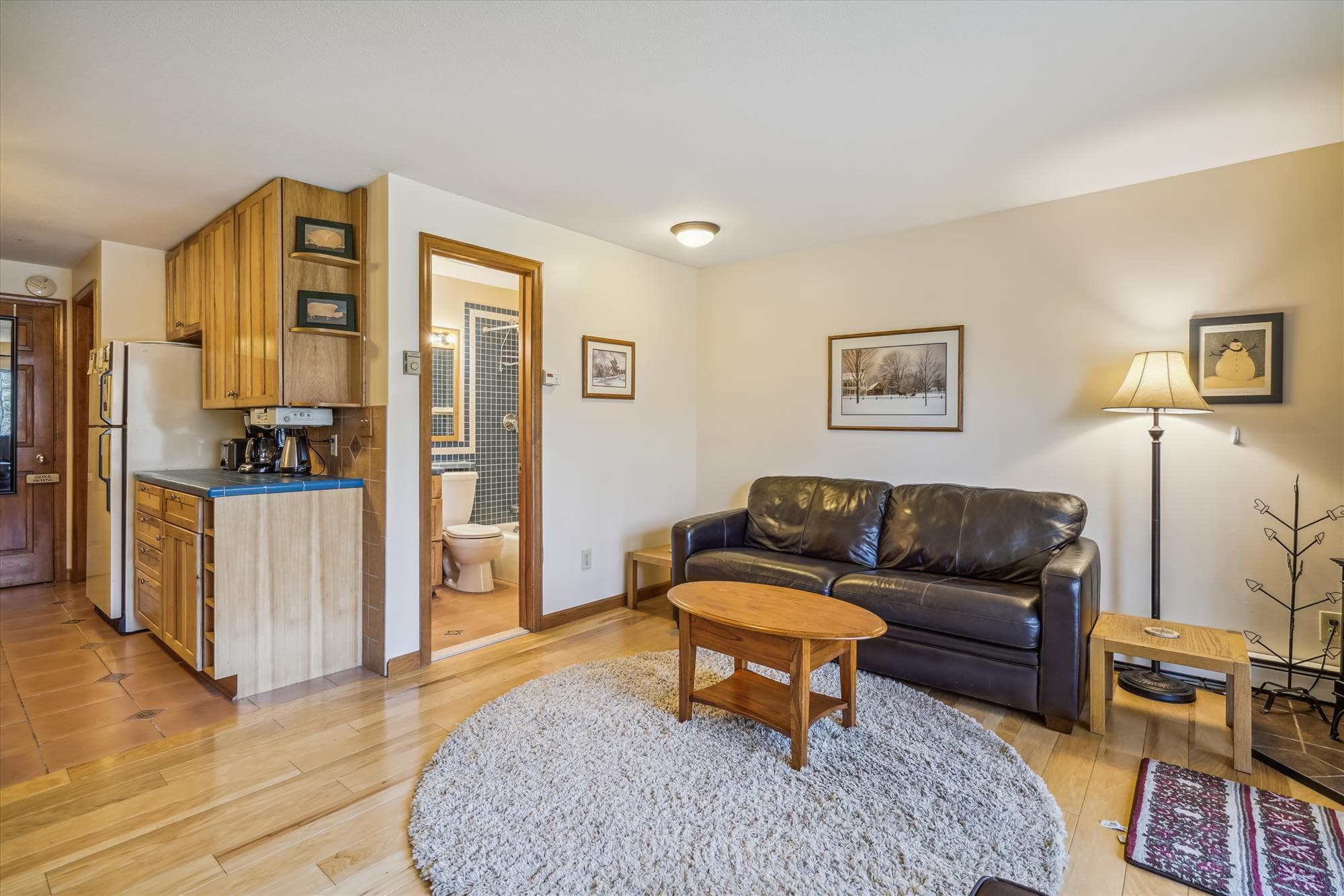 Living room with plenty of seating for your small group. Propane stove to enjoy and warm up after those cold days or just to add some ambiance to your evening. Tons of natural light from your slider door access to back yard and small patio.