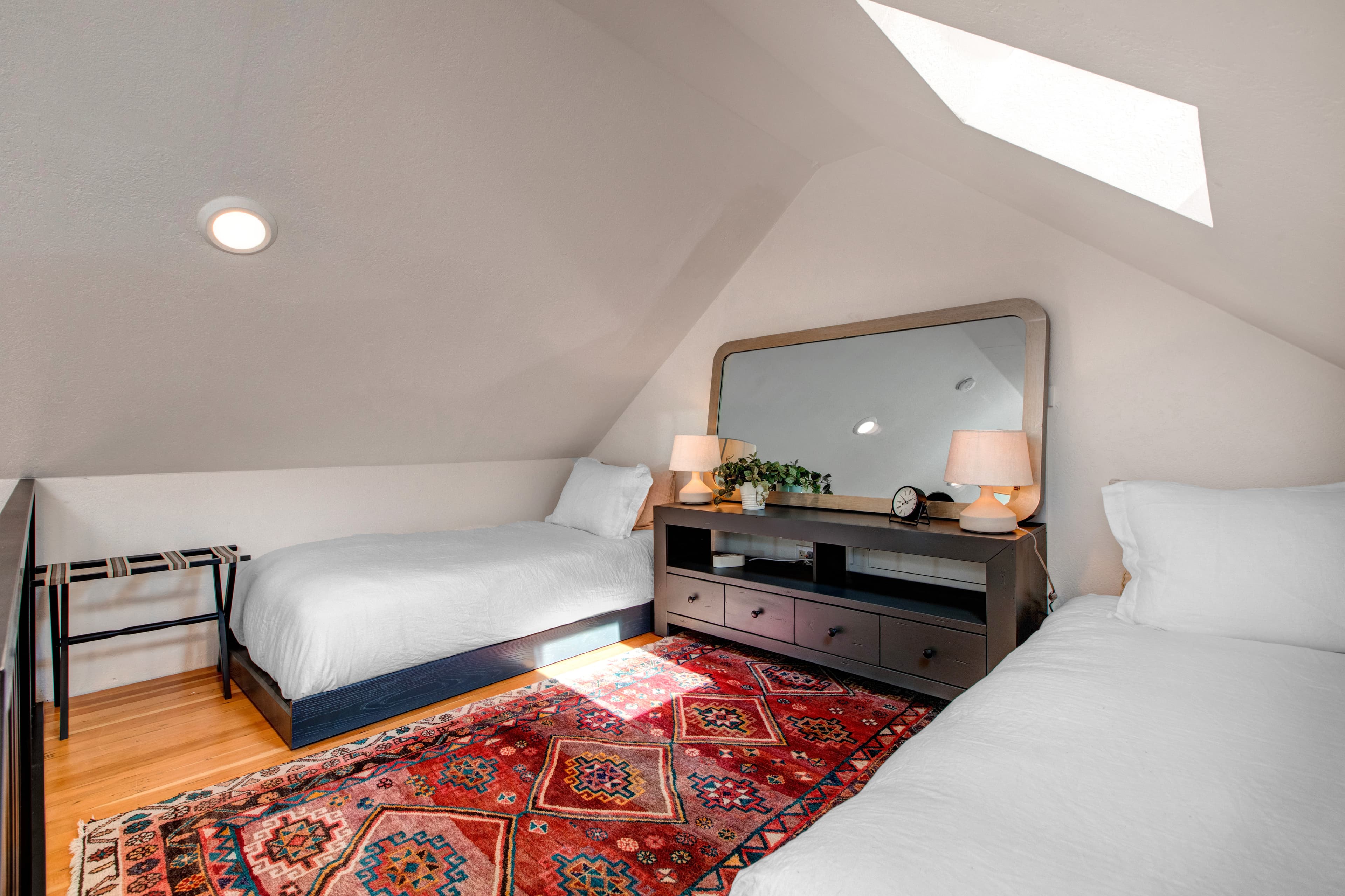Master king bedroom, with ensuite bathroom and vaulted ceilings with a ladder up to an open loft with two additional twin beds.