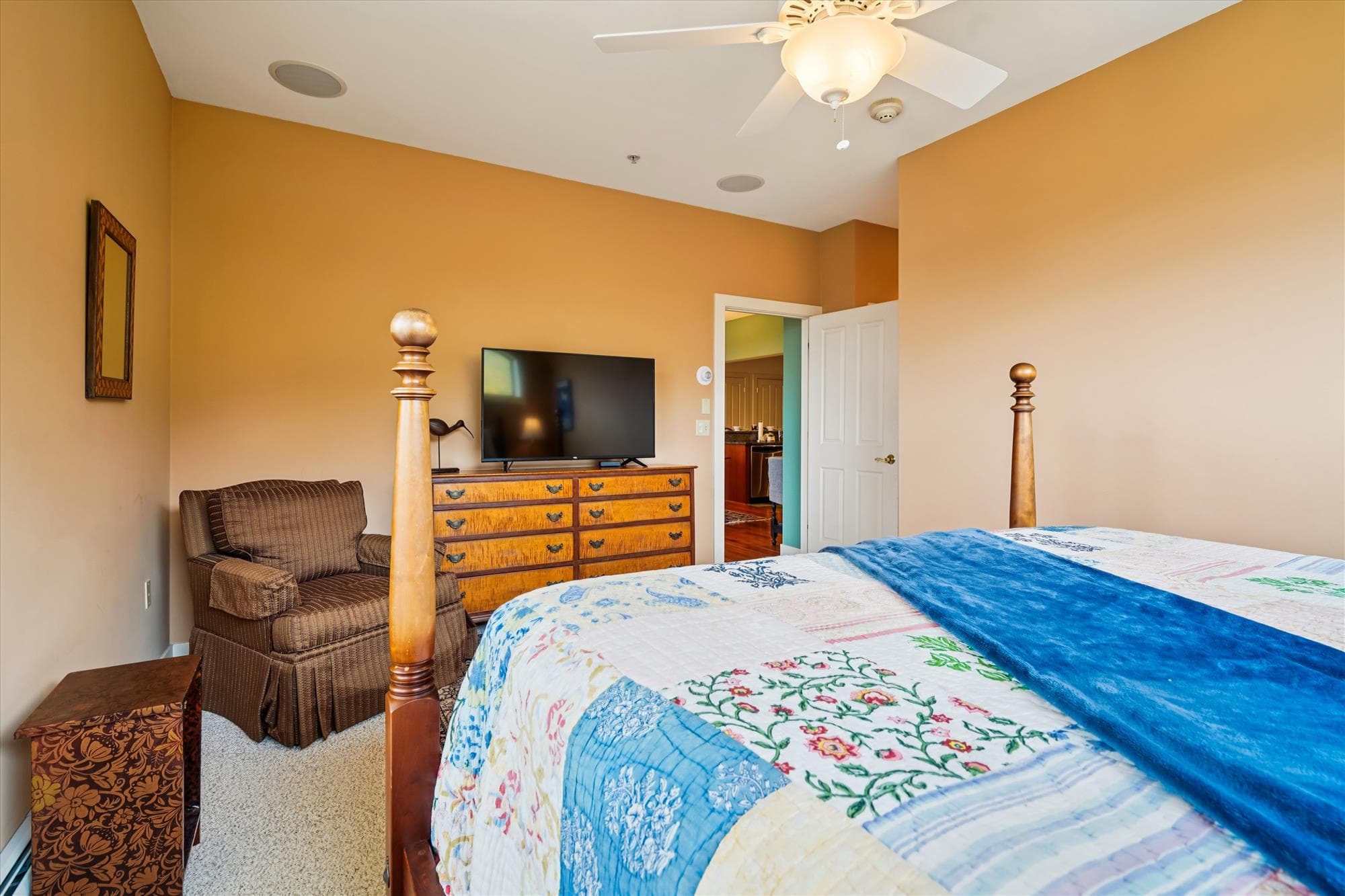 Spacious king suite featuring a private bath with a whirlpool tub and large windows showcasing mountain views. Classic furniture and warm tones create a calm retreat after a day on the slopes.