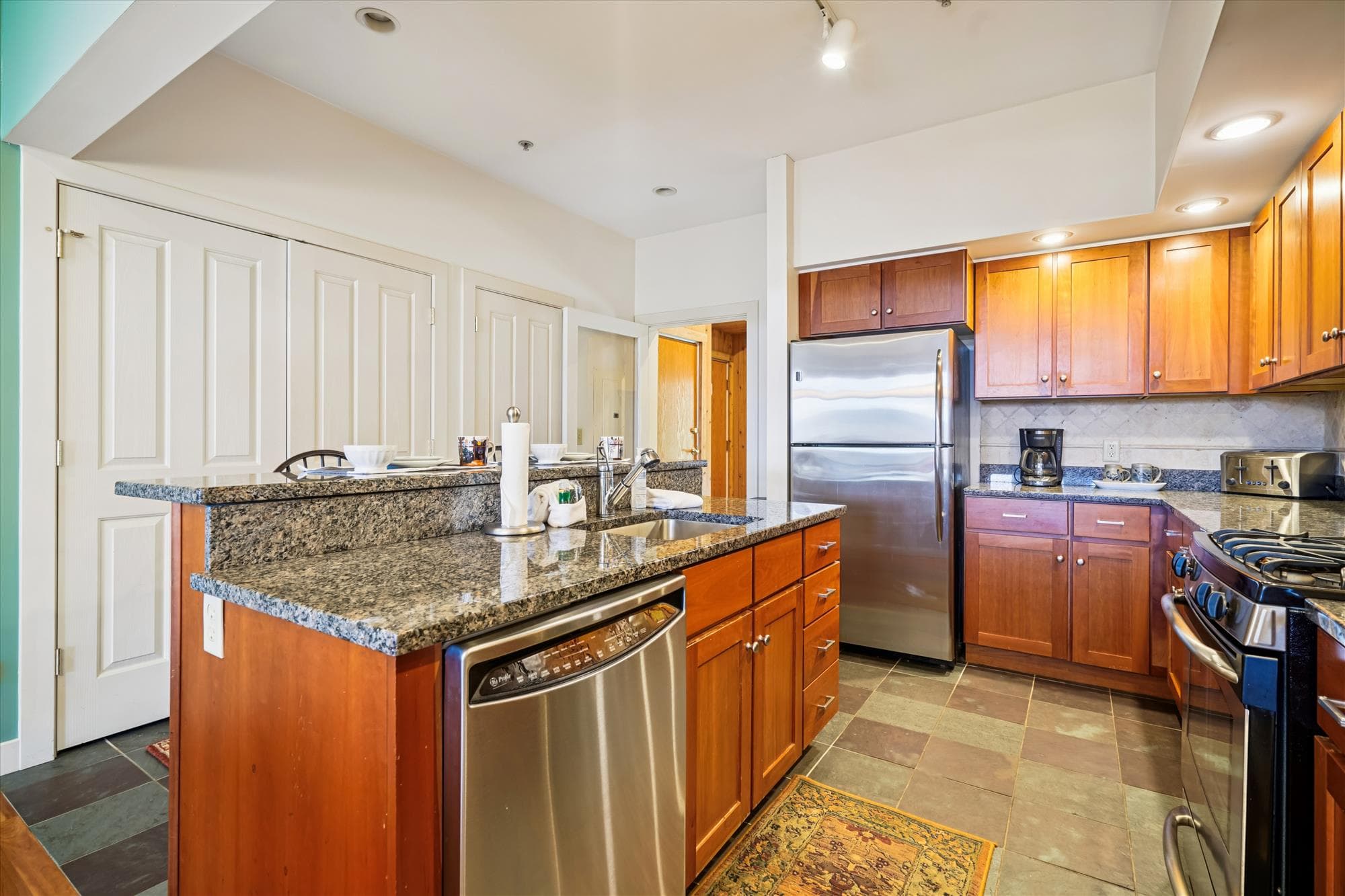 Fully equipped kitchen with granite counters, stainless-steel appliances, and a raised breakfast bar. Ideal for family meals, morning coffee, or après-ski snacks.