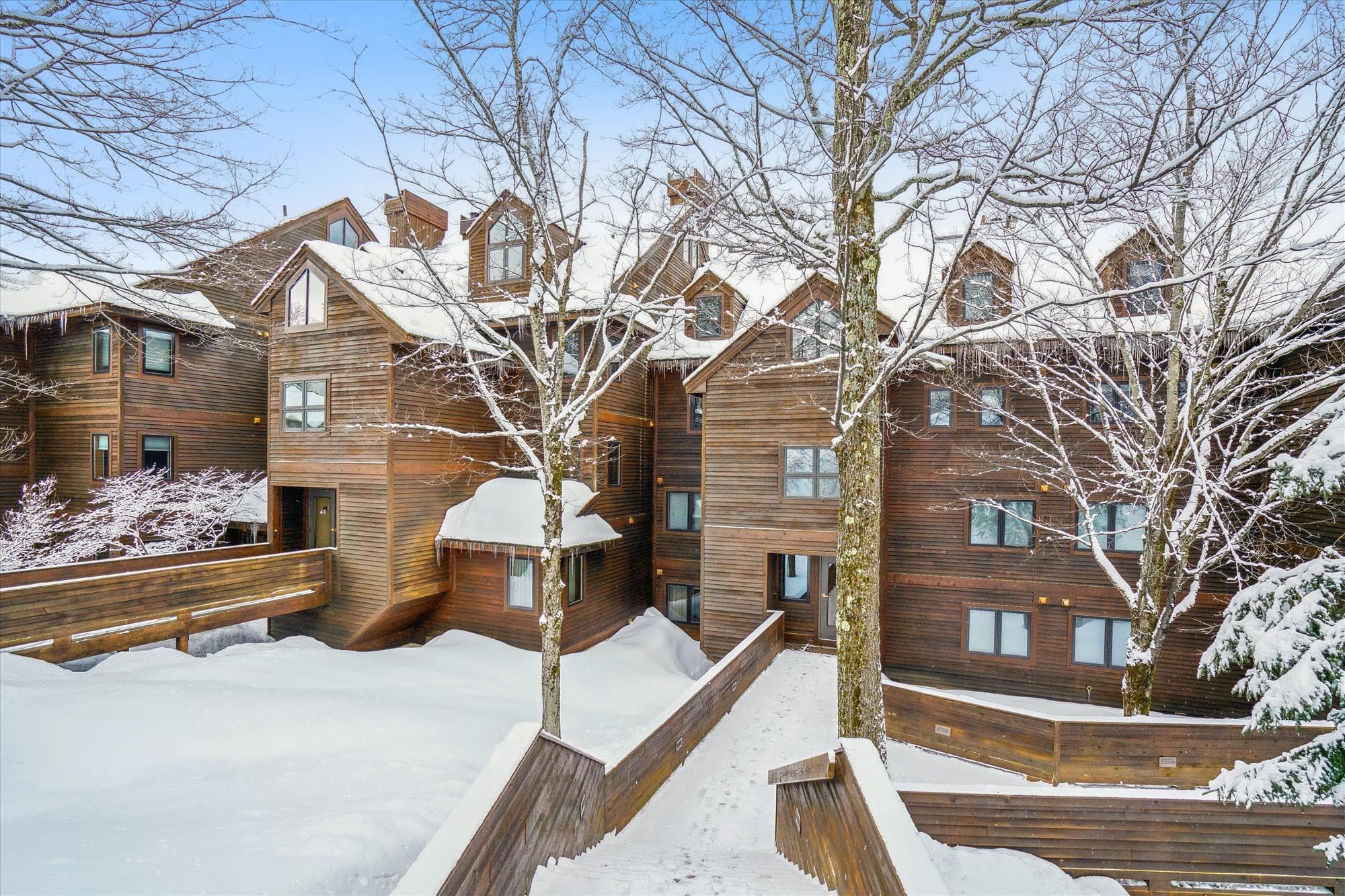 The Highridge condominium community offers a classic Vermont mountain setting surrounded by trees and scenic winter views.