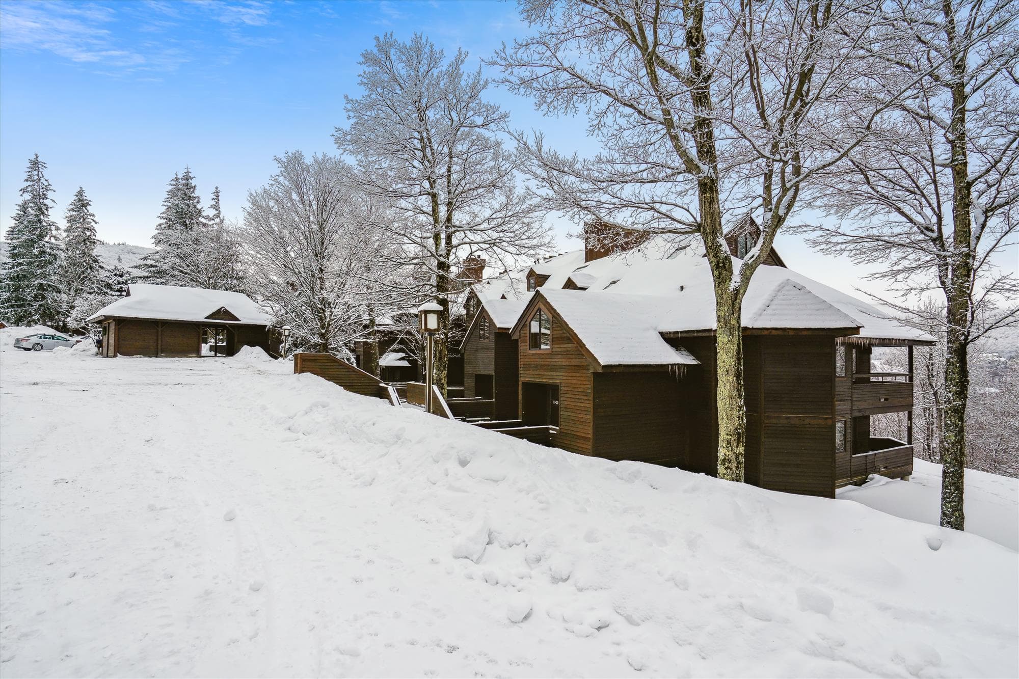 Highridge Condominiums offer a peaceful mountain setting surrounded by trees and beautiful winter scenery.