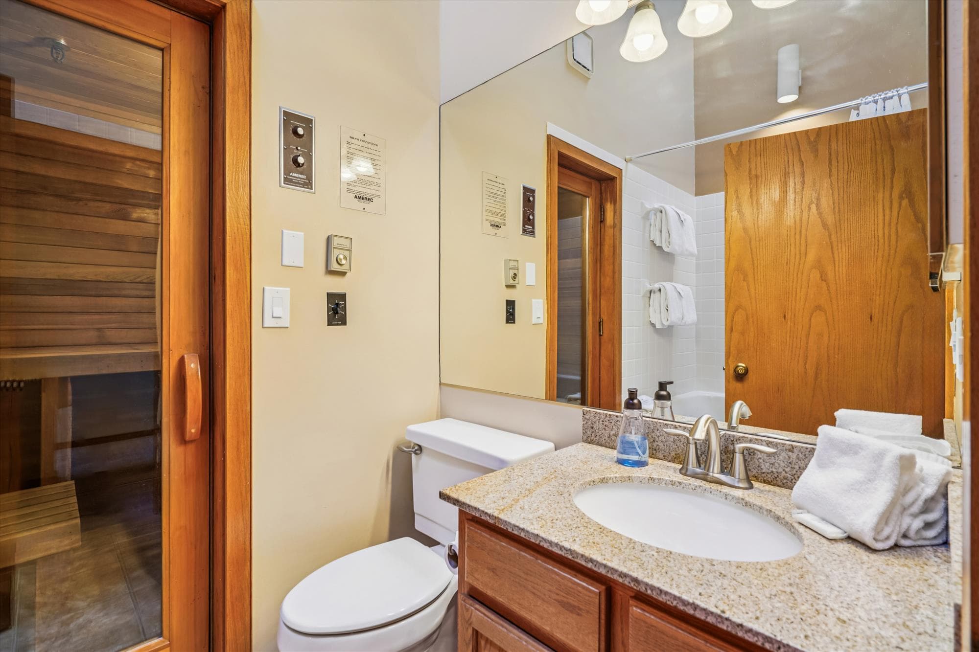 Full bathroom with granite vanity and direct access to the private sauna.