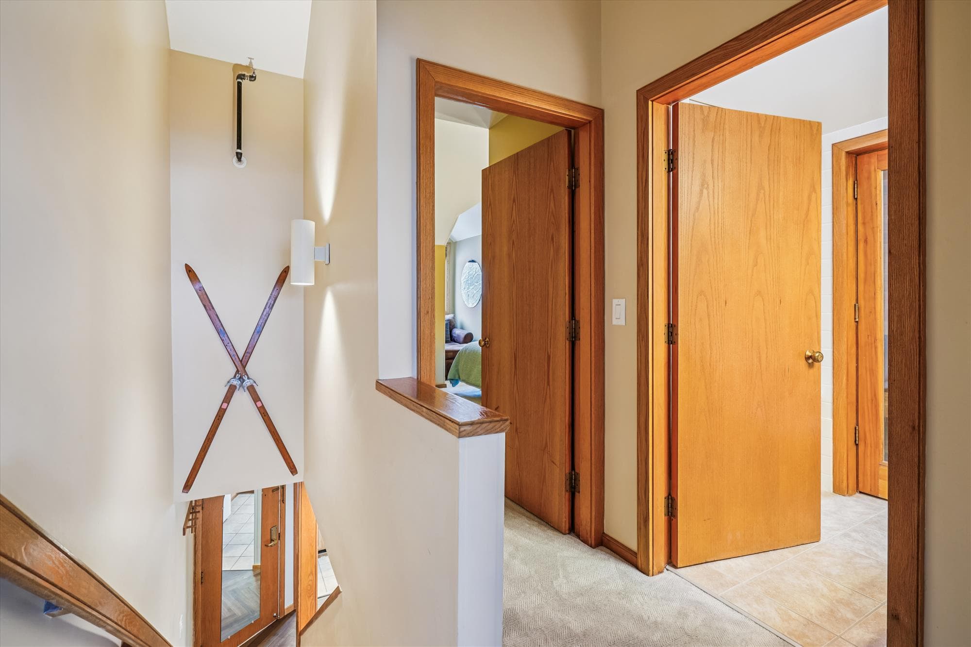 Upper level hallway connecting the bedrooms and bathroom with views overlooking the main living area below.