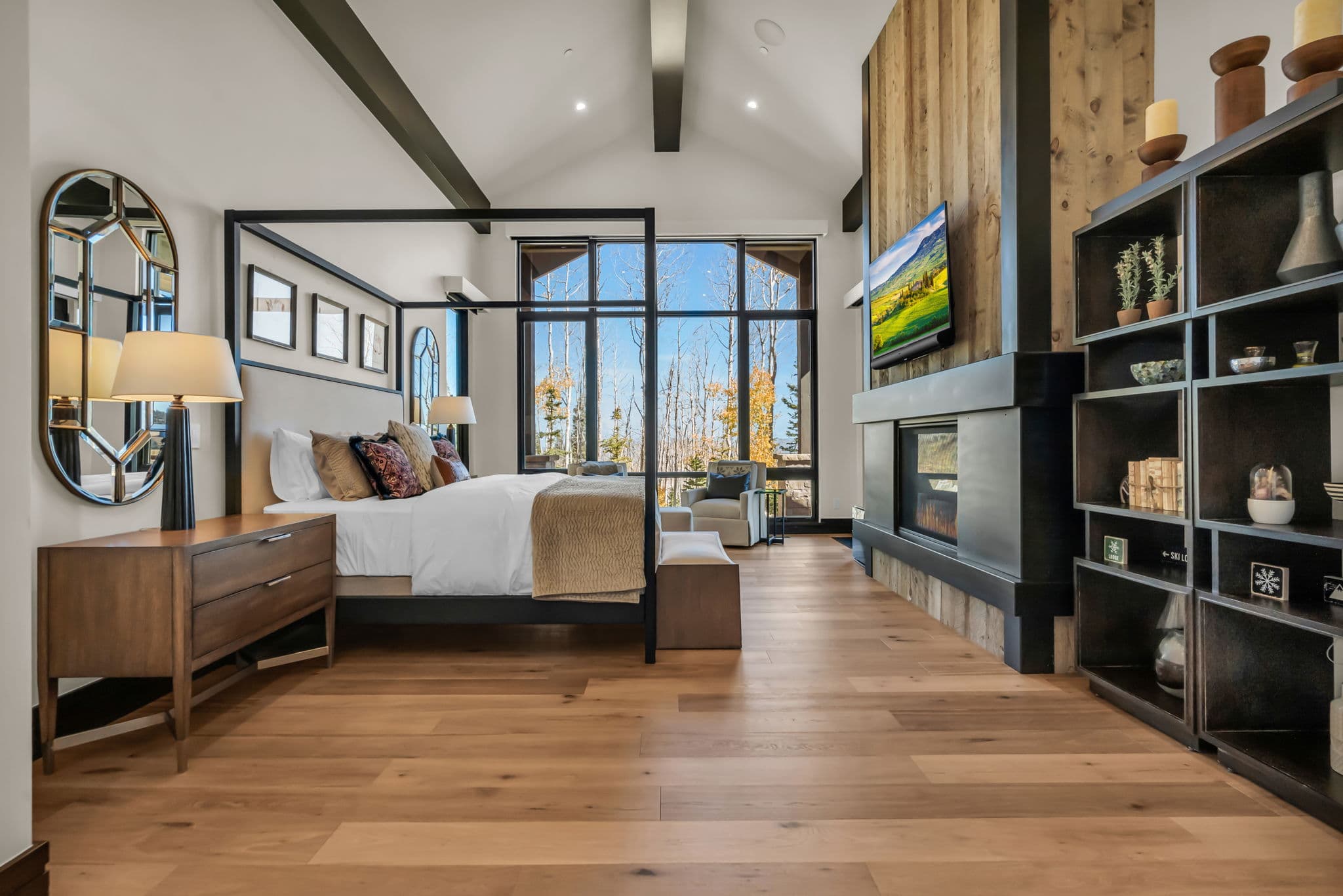 Bedroom with Four-Poster Bed, Bedside Table, Bed Bench, TV, and Fireplace