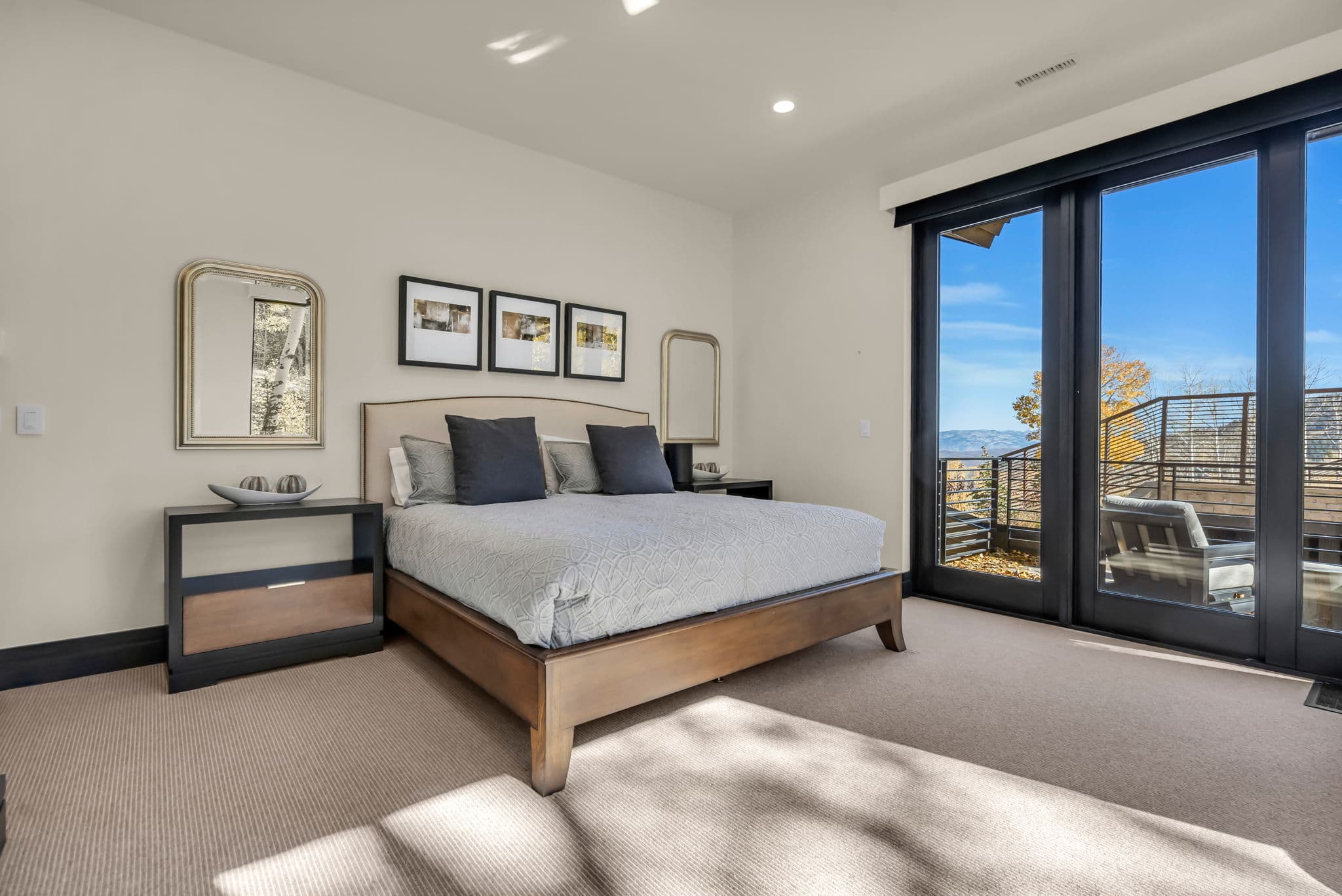 Large Bed, Bedside Table, Mirror and Sliding Doors to the Balcony