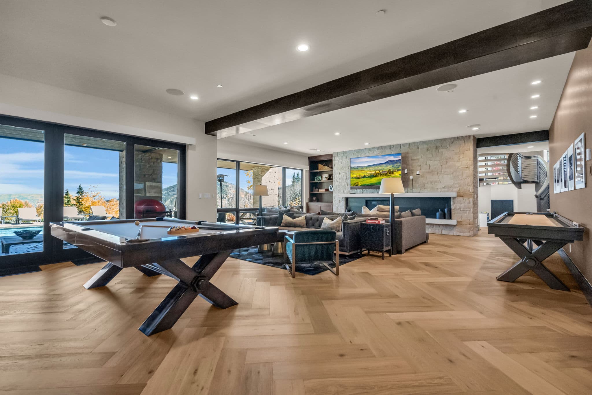 Pool Table, Sofa, Accent Chair, TV, and Sliding Doors to the Pool Area