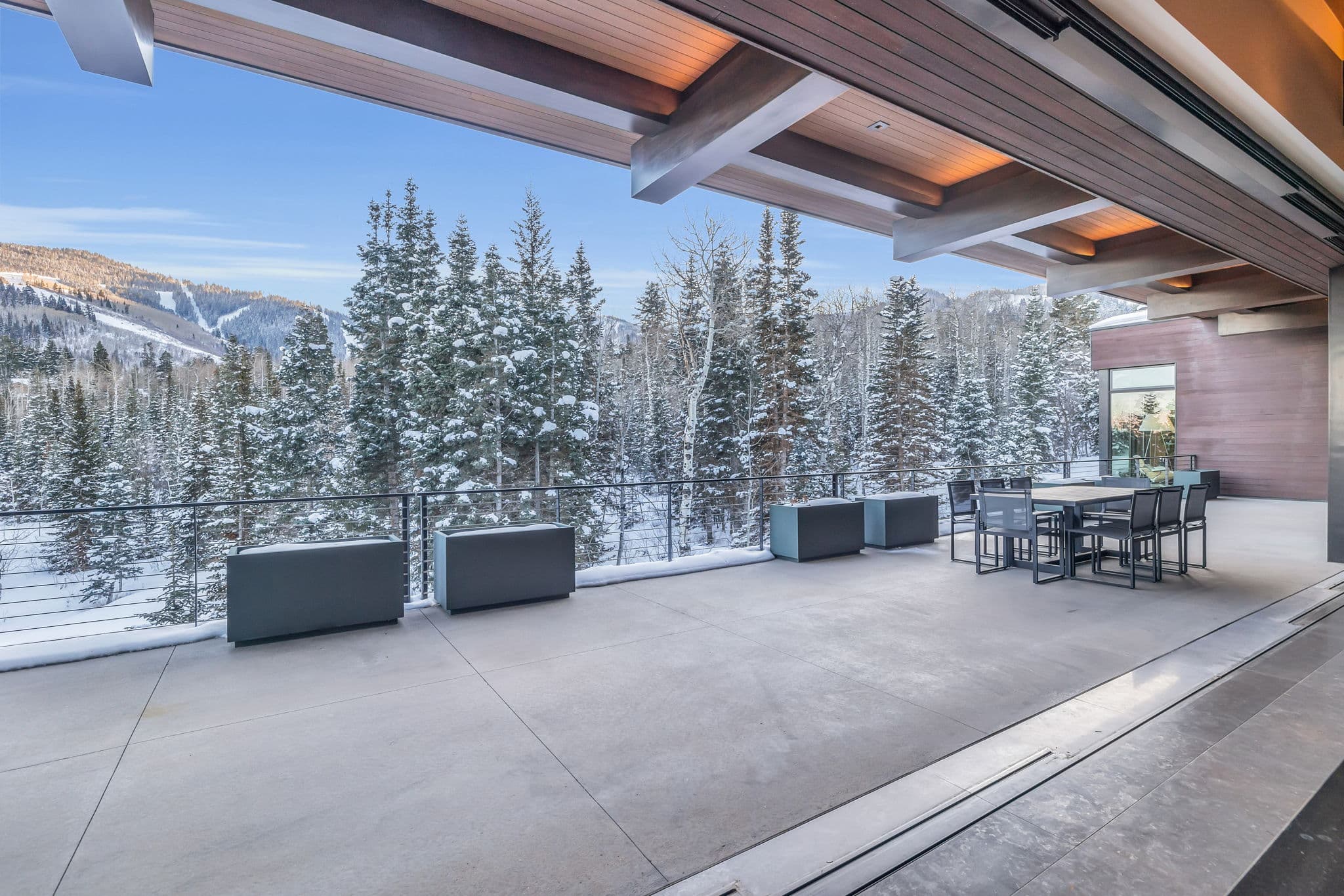 A spacious  terrace with dining space and snowy views.