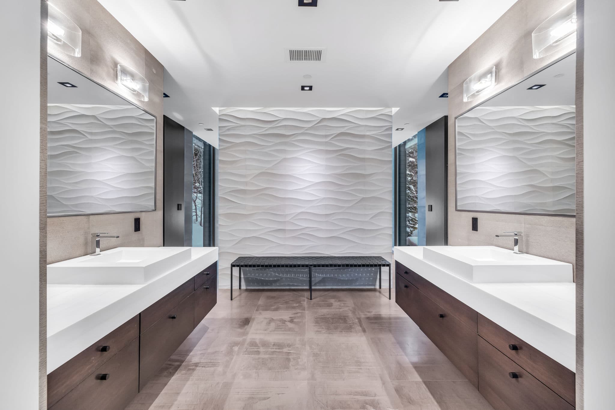 A modern bathroom with dual vanities and elegant textures.