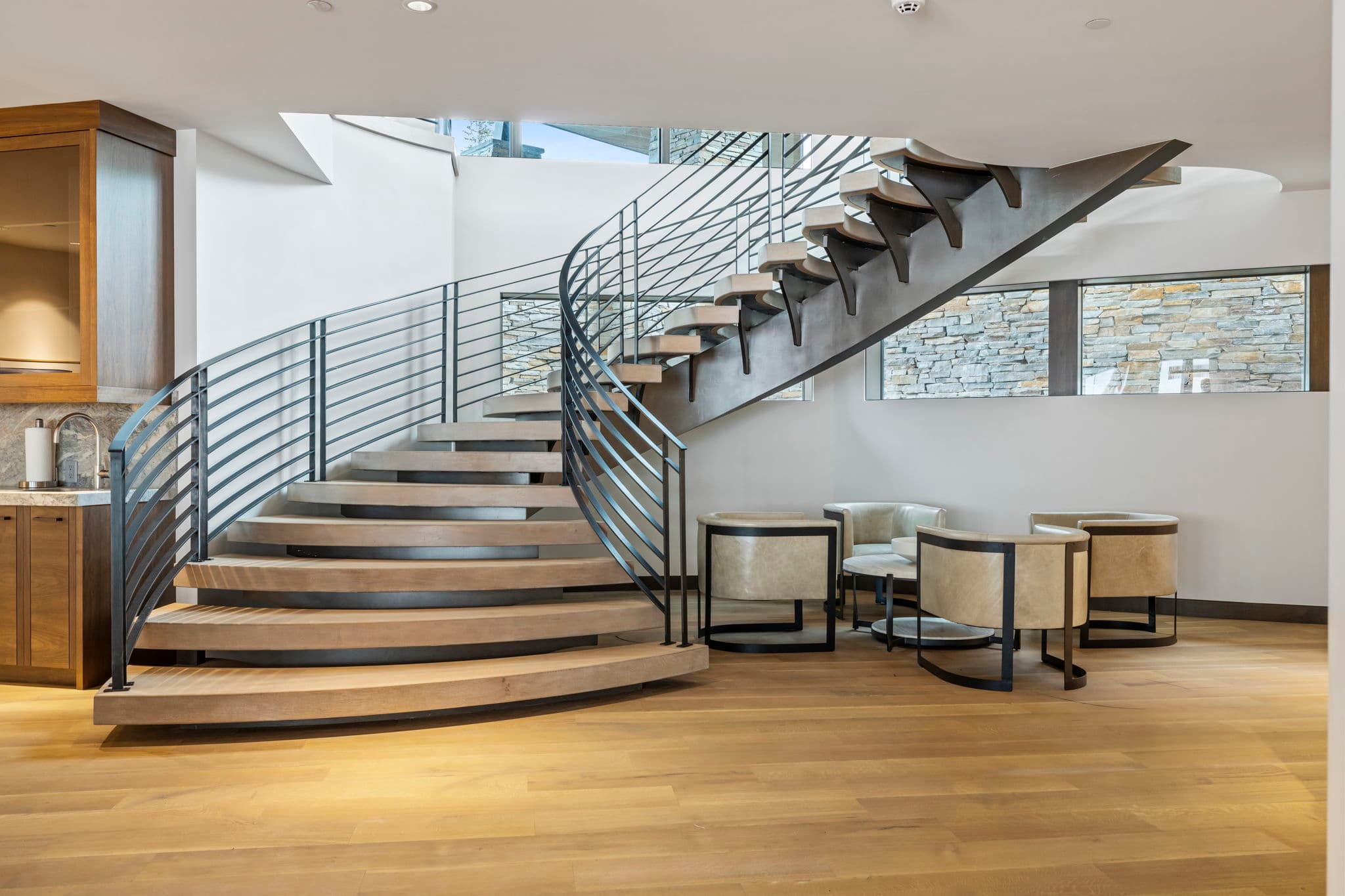 A view of a staircase with a seating area beneath it.