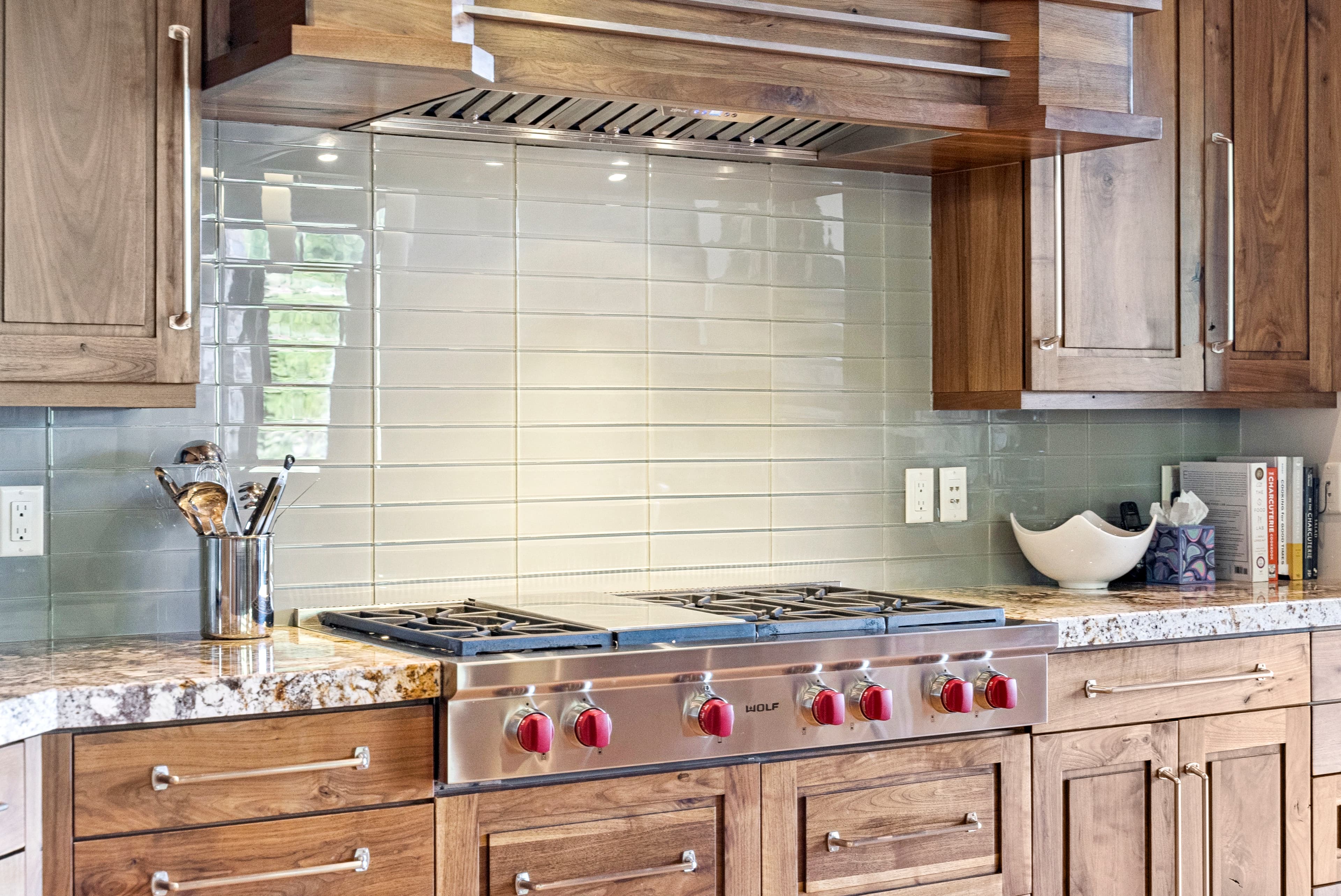 chefs stove with custom tile backsplash